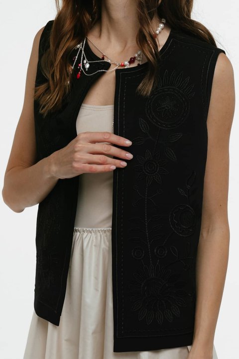 Embroidered women's vest "Petrykivka" black - bright ornaments on a classic background.