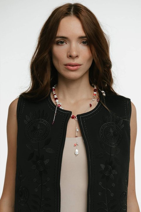 Embroidered women's vest "Petrykivka" black - bright ornaments on a classic background.