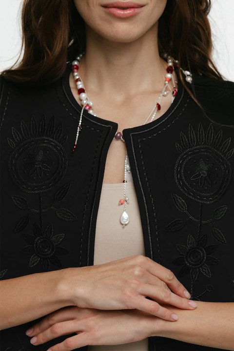 Embroidered women's vest "Petrykivka" black - bright ornaments on a classic background.